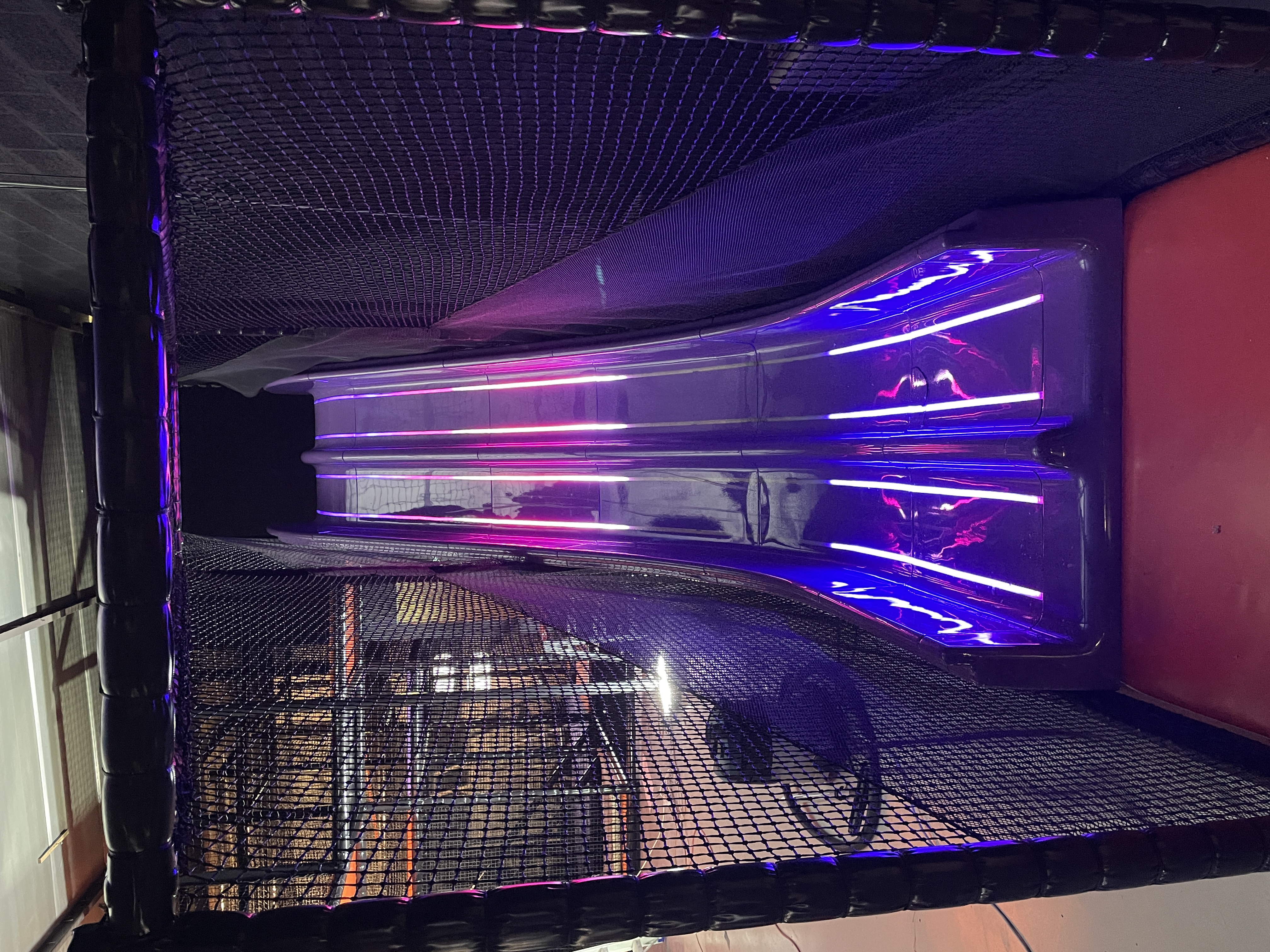 LEDs beneath a new playground slide shining through transparent lines in the slide